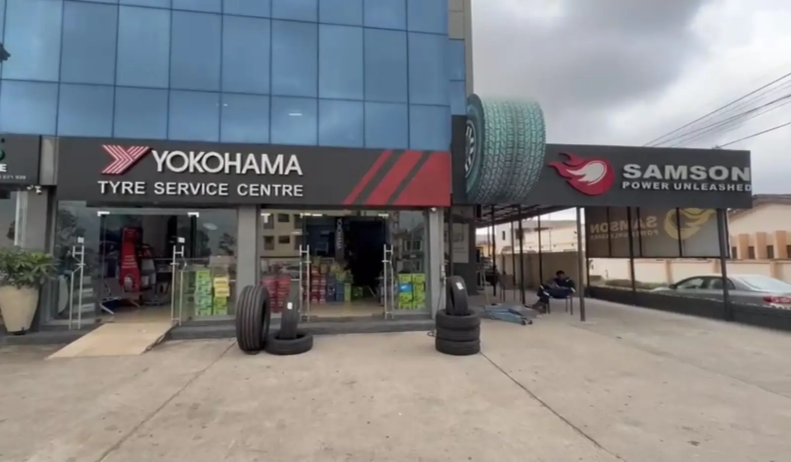 Yokohama Tyre Service Centre storefront with new tyres stacked outside